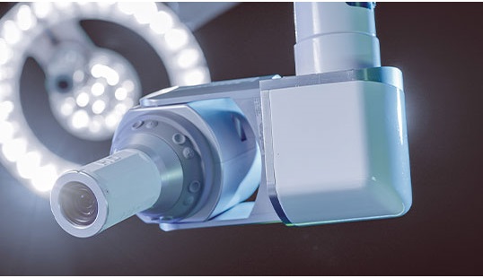 STERIS overhead surgical light with central tandem ceiling mount.