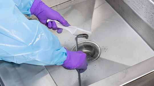 Manual cleaning surgical instruments at a sink
