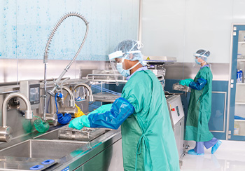 Technician at the sink in a Sterile Processing Department