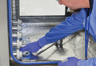 Technician inspecting washer/disinfector