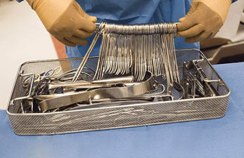 Technician holding Surgical Instruments