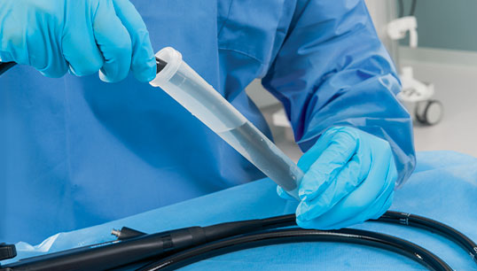 An endoscope being cleaned with PRE-KLENZ Soak Shield.
