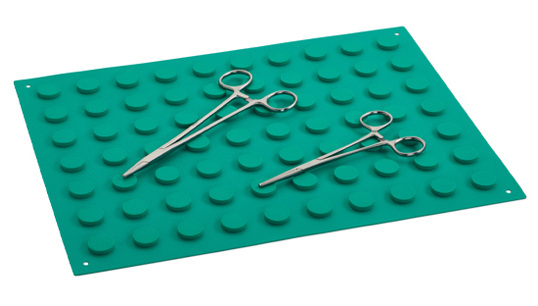 Magnetic mat holding two pairs of surgical scissors.